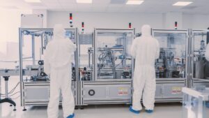 technicians work on automation equipment in clean room